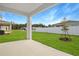 Covered patio overlooking a spacious backyard with grassy lawn at 4212 Sawtooth Ct, Tavares, FL 32778