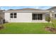 Well-maintained house with a covered patio and a grassy backyard at 4212 Sawtooth Ct, Tavares, FL 32778