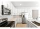 Modern kitchen with white cabinets and stainless steel appliances at 4212 Sawtooth Ct, Tavares, FL 32778