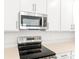 Stainless steel range and microwave in a modern kitchen at 4212 Sawtooth Ct, Tavares, FL 32778