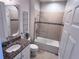 Updated bathroom with tiled shower and tub, granite vanity, and modern fixtures at 8118 Platts Ave, Orlando, FL 32832
