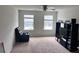 Bright bedroom featuring large windows, comfortable seating, and entertainment center at 8118 Platts Ave, Orlando, FL 32832