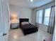 Cozy bedroom with tiled floors, a comfortable bed and bright natural light at 8118 Platts Ave, Orlando, FL 32832