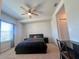 Cozy bedroom with fan, window, and neutral carpet at 8118 Platts Ave, Orlando, FL 32832