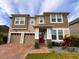Charming two-story home with a two-car garage, brick drive, and lush front lawn at 8118 Platts Ave, Orlando, FL 32832