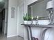 Close-up of a stylish foyer table with lamps, a mirror, and decorative accents at 8118 Platts Ave, Orlando, FL 32832