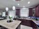 Stylish kitchen showcases granite countertops, modern pendants, and stainless appliances at 8118 Platts Ave, Orlando, FL 32832