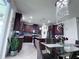 Modern kitchen and dining area with stainless appliances, wine cooler and elegant chandelier at 8118 Platts Ave, Orlando, FL 32832
