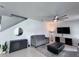 Neutral toned living room featuring stylish decor, modern ceiling fan and plush seating at 8118 Platts Ave, Orlando, FL 32832