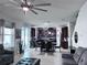 Open-concept living space with a dining area, modern chandelier, and chef's kitchen at 8118 Platts Ave, Orlando, FL 32832