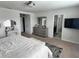Bright main bedroom featuring ensuite bathroom, dresser, and vanity area at 8118 Platts Ave, Orlando, FL 32832