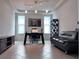 Spacious home office with stylish desk, cozy seating, and abundant natural light at 8118 Platts Ave, Orlando, FL 32832