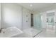 Spa-like bathroom with a soaking tub and a large walk-in shower at 107 Hampton Loop, Davenport, FL 33837
