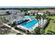 Large community pool with adjacent clubhouse at 107 Hampton Loop, Davenport, FL 33837