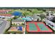 Aerial view showcasing community amenities including a pool, tennis courts, and playground at 107 Hampton Loop, Davenport, FL 33837