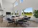 Bright dining room with large windows and view of backyard at 107 Hampton Loop, Davenport, FL 33837