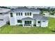 Two-story home with gray roof, white exterior, and sliding glass doors at 107 Hampton Loop, Davenport, FL 33837
