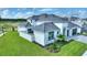Two-story home with gray roof, white exterior, and landscaped lawn at 107 Hampton Loop, Davenport, FL 33837