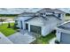 Two-story home with gray roof, white exterior, two-car garage, and landscaped lawn at 107 Hampton Loop, Davenport, FL 33837