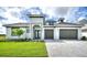 Beautiful two-story home featuring a well-manicured lawn, brick driveway, and a spacious two-car garage at 107 Hampton Loop, Davenport, FL 33837