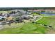 Aerial view of a golf course with the clubhouse and the fairway at 107 Hampton Loop, Davenport, FL 33837