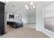 Modern kitchen with dark cabinetry, island, and stainless steel appliances at 107 Hampton Loop, Davenport, FL 33837