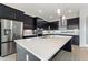 Modern kitchen with stainless steel appliances and a large island at 107 Hampton Loop, Davenport, FL 33837