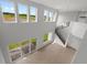 Two-story living room with a modern staircase and lots of natural light at 107 Hampton Loop, Davenport, FL 33837
