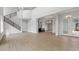 Open living area with high ceilings, tile floors, and modern staircase at 107 Hampton Loop, Davenport, FL 33837