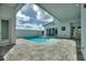 Relaxing backyard pool area boasts a serene setting with a clear blue pool, patio, and a privacy wall at 107 Hampton Loop, Davenport, FL 33837