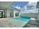 Stunning outdoor pool with a sun shelf and travertine tile deck at 107 Hampton Loop, Davenport, FL 33837