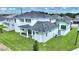 The rear exterior of the home offers a large lawn and patio perfect for entertaining or relaxing outdoors at 107 Hampton Loop, Davenport, FL 33837
