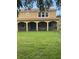 Large backyard featuring a covered, screened-in patio and a sprawling green lawn at 11774 Via Lucerna Cir, Windermere, FL 34786