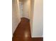 Hallway featuring hardwood floors, access to multiple rooms, and neutral paint at 11774 Via Lucerna Cir, Windermere, FL 34786