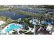 Aerial view of community amenities including pools, a playground, beach volleyball, and walking trails at 1612 Herrons Green Path, Kissimmee, FL 34747