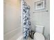 Clean bathroom featuring a tub with shower and a white and blue floral shower curtain at 1612 Herrons Green Path, Kissimmee, FL 34747