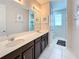 Bathroom with double sink vanity, well-lit mirror, and convenient access to a separate shower and toilet area at 1612 Herrons Green Path, Kissimmee, FL 34747