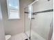 This well-lit bathroom offers a modern, tiled shower with glass doors for a sleek and clean design at 1612 Herrons Green Path, Kissimmee, FL 34747