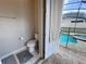 Convenient half bathroom offering easy pool access with tile floors and a neutral color palette at 1612 Herrons Green Path, Kissimmee, FL 34747