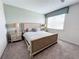 This is a well-lit carpeted bedroom with a large bed flanked by nightstands, illuminated by lamps at 1612 Herrons Green Path, Kissimmee, FL 34747