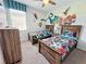 Fun ' bedroom featuring twin beds, wooden furniture, and superhero wall art at 1612 Herrons Green Path, Kissimmee, FL 34747
