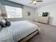 Bright bedroom with plush carpeting, an ample window, and a comfortable bed complete with soft bedding and decor at 1612 Herrons Green Path, Kissimmee, FL 34747