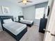 Bright bedroom with twin beds, dark wood furniture, and a striped valence at 1612 Herrons Green Path, Kissimmee, FL 34747