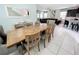 Formal dining room with seating for six, neutral decor, and an open concept design to the kitchen and living room at 1612 Herrons Green Path, Kissimmee, FL 34747