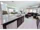 Open concept kitchen boasts granite countertops, stainless steel appliances, and seamless flow to the living room at 1612 Herrons Green Path, Kissimmee, FL 34747