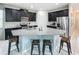 Contemporary kitchen with granite countertops, stainless steel appliances, dark cabinets, and a center island with bar seating at 1612 Herrons Green Path, Kissimmee, FL 34747