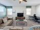 Spacious living room featuring comfortable seating, a large television, and a dedicated workspace for productivity at 1612 Herrons Green Path, Kissimmee, FL 34747