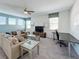The bright living room with plush seating has an abundance of natural light and a spacious layout at 1612 Herrons Green Path, Kissimmee, FL 34747