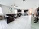 Open-concept living area featuring a spacious layout, tile flooring, and a modern kitchen with a center island at 1612 Herrons Green Path, Kissimmee, FL 34747
