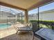 Relaxing screened patio with lounge chairs, table, and view of the pool at 1612 Herrons Green Path, Kissimmee, FL 34747